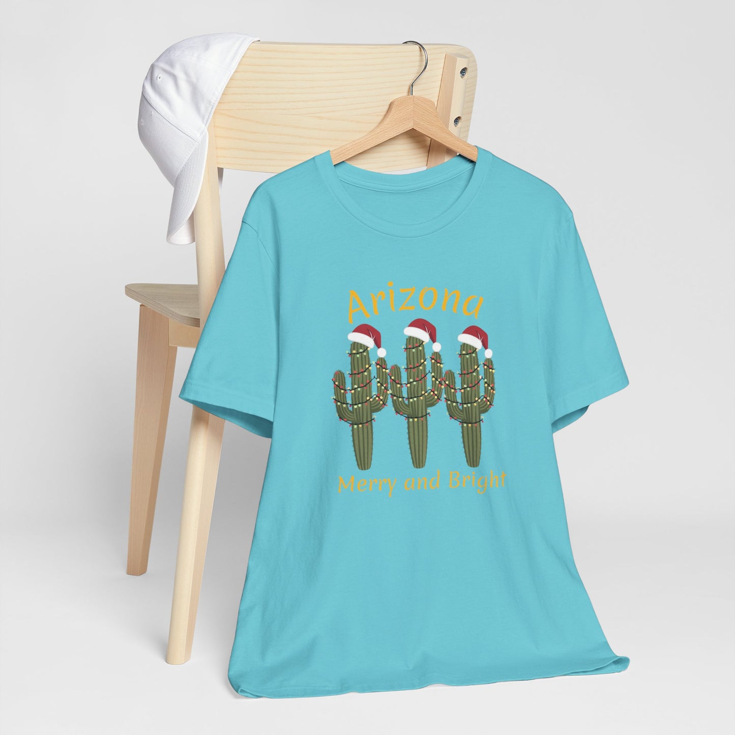 Arizona Christmas Saguaro cactus with festive lights and Santa caps, Unisex Cactus Tee, Holiday souvenir