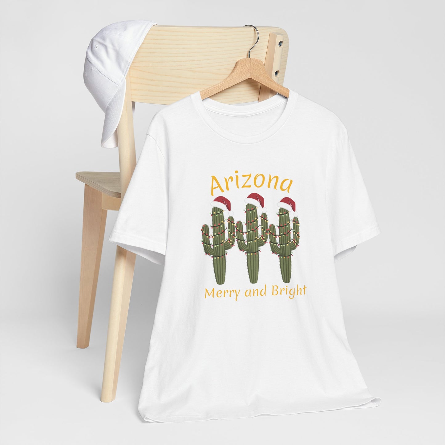 Arizona Christmas Saguaro cactus with festive lights and Santa caps, Unisex Cactus Tee, Holiday souvenir
