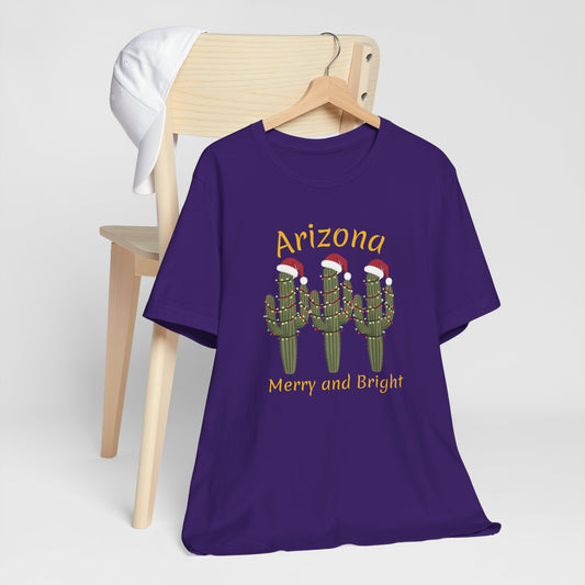 Arizona Christmas Saguaro cactus with festive lights and Santa caps, Unisex Cactus Tee, Holiday souvenir